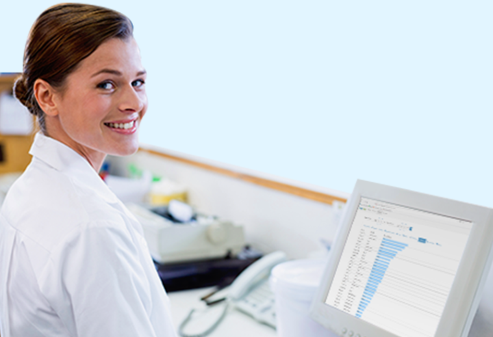 Female medical technician reviewing at Pevco software