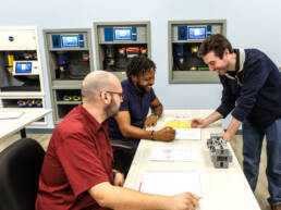 Instructor going over class materials with two trainees