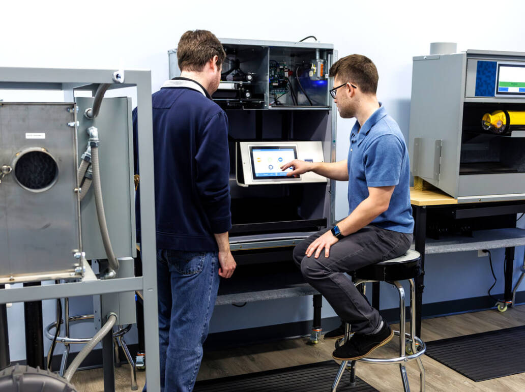 Two people working at a station as part of training